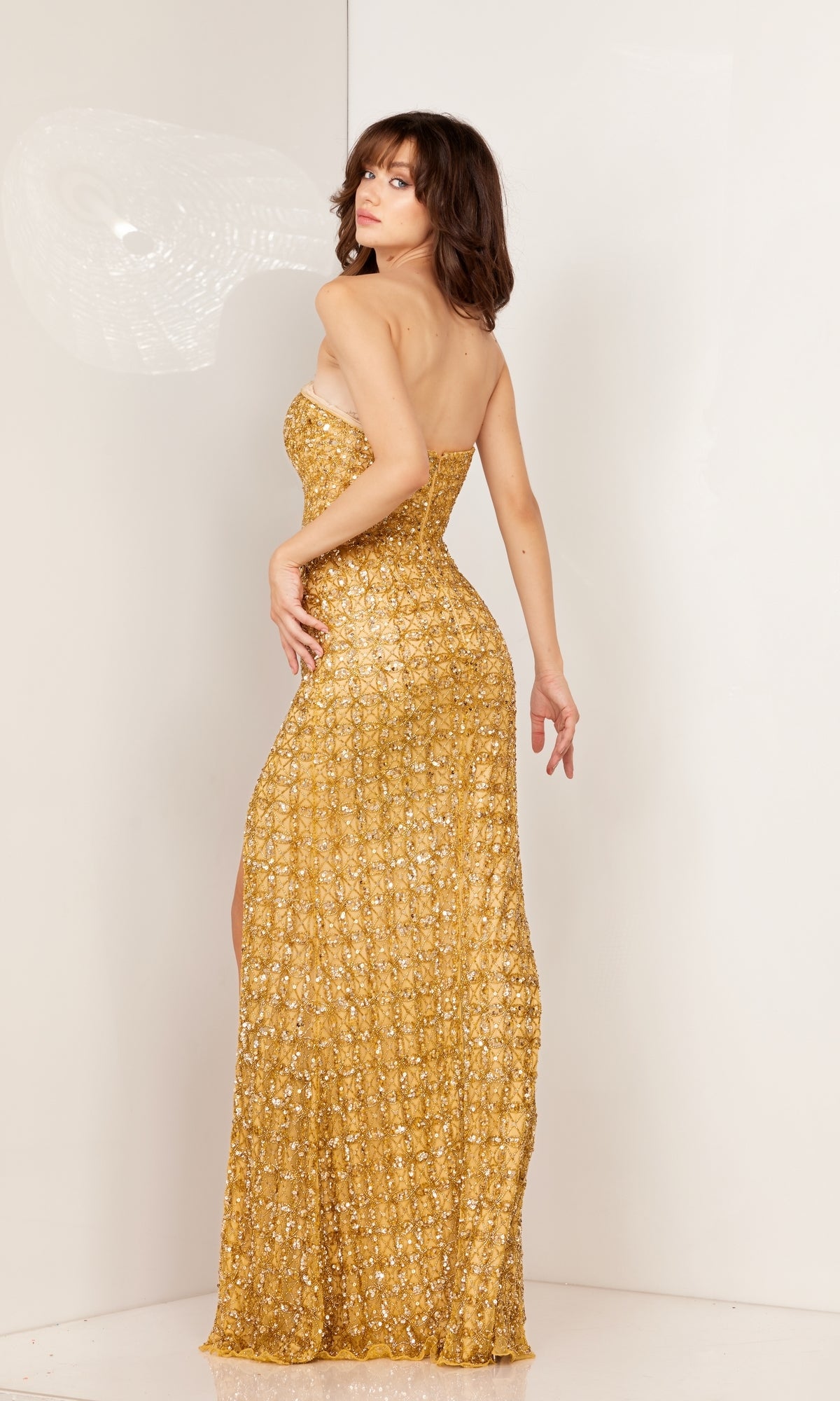 A woman models the Strapless Beaded-Print Long Prom Dress 1119, posing with her back slightly turned toward the camera against a plain white background.